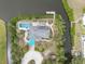 Overhead view of a home on a canal with a dock, pool, and lush landscaping at 1410 San Jose Dr, Englewood, FL 34223