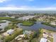 Aerial view of a waterfront community with houses, canals, and the Gulf of Mexico at 1410 San Jose Dr, Englewood, FL 34223