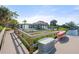 Property featuring waterfront views with a dock, tiki hut, and pool, perfect for outdoor enjoyment at 1410 San Jose Dr, Englewood, FL 34223
