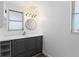 Stylish bathroom vanity with a modern round mirror and ample cabinet space at 1410 San Jose Dr, Englewood, FL 34223