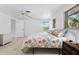 Bright bedroom featuring a standard window with natural light, neutral walls, ceiling fan, and tile flooring at 1410 San Jose Dr, Englewood, FL 34223