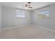 Comfortable bedroom with standard windows providing natural light, neutral walls, and a ceiling fan at 1410 San Jose Dr, Englewood, FL 34223