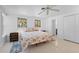 Bright bedroom featuring a seashell-themed quilt, two windows, and terrazzo floors at 1410 San Jose Dr, Englewood, FL 34223