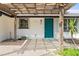 Charming home featuring a bright turquoise front door under a pergola, adding curb appeal and style at 1410 San Jose Dr, Englewood, FL 34223