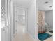 Hallway with a glimpse into a bedroom and bathroom with seashell-themed shower curtain at 1410 San Jose Dr, Englewood, FL 34223