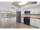 Bright kitchen features stainless steel appliances and white cabinets with butcher block countertops at 1410 San Jose Dr, Englewood, FL 34223