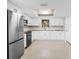 Bright kitchen features stainless steel appliances and white cabinets with butcher block countertops at 1410 San Jose Dr, Englewood, FL 34223