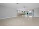 Open-concept living room with dining area, tile flooring, and views to an enclosed sunroom at 1410 San Jose Dr, Englewood, FL 34223
