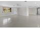 Bright living room featuring neutral paint, durable floors, standard window, and access to other rooms at 1410 San Jose Dr, Englewood, FL 34223