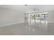 Bright living room featuring neutral paint, ceiling fan, seamless access to an enclosed sunroom, and durable floors at 1410 San Jose Dr, Englewood, FL 34223
