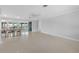 Spacious living room with dining area, ceiling fan, and seamless access to an enclosed sunroom with water views at 1410 San Jose Dr, Englewood, FL 34223