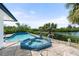 Relaxing pool and spa area with scenic waterfront views and lush tropical landscaping at 1410 San Jose Dr, Englewood, FL 34223
