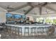 Resort-style bar with multiple TV screens, ceiling fans and fully stocked liquor shelves at 14121 Heritage Landing Blvd # 734, Punta Gorda, FL 33955