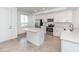 Bright kitchen features white cabinetry, stainless steel appliances, and a center island at 14121 Heritage Landing Blvd # 734, Punta Gorda, FL 33955