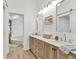 Spa-like main bathroom with double vanity, sliding barn door, modern mirrors, and luxury finishes at 1489 17Th W St, Palmetto, FL 34221