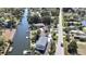 Aerial view of waterfront homes featuring private docks and canal access near roadways at 14914 Old Dixie Hwy, Hudson, FL 34667