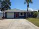 Charming single-Gathering home with a well-maintained lawn, attached garage, and a beautiful palm tree at 14914 Old Dixie Hwy, Hudson, FL 34667