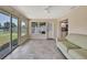 Bright living room connected to kitchen with tile floors, sliding glass doors, and backyard views at 14914 Old Dixie Hwy, Hudson, FL 34667