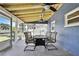 The covered patio features a table and chairs, perfect for outdoor dining at 14914 Old Dixie Hwy, Hudson, FL 34667