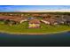 Aerial view of a beautiful home on the lake in a residential neighborhood, featuring a private pool and landscaped yard at 15169 Vivaldi Dr, Nokomis, FL 34275