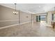 Bright living room boasts tile floors, elegant chandelier, and sliding glass doors to the water at 15169 Vivaldi Dr, Nokomis, FL 34275