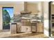 Premium outdoor kitchen featuring stainless steel appliances and ample counter space at 15169 Vivaldi Dr, Nokomis, FL 34275