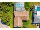 Aerial view of the home showcasing the roof, screened-in pool, and meticulously manicured yard at 1525 Fleetwood Dr, Sarasota, FL 34232