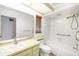 Bathroom with neutral countertops, a large mirror, and a combined shower and tub at 1525 Fleetwood Dr, Sarasota, FL 34232
