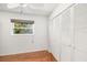 Bedroom with large closet, ceiling fan, and window looking out to the yard at 1525 Fleetwood Dr, Sarasota, FL 34232