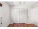 Bedroom with a closet and neutral walls and dark, glossy wood floors at 1525 Fleetwood Dr, Sarasota, FL 34232