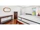 Bright bedroom featuring wood floors, a ceiling fan, and a wooden mirror at 1525 Fleetwood Dr, Sarasota, FL 34232