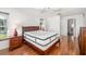 Bedroom boasts gleaming hardwood floors and large bed with side tables at 1525 Fleetwood Dr, Sarasota, FL 34232