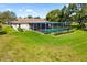 Aerial view showcasing the home's backyard, screened pool, and lush landscaping at 1525 Fleetwood Dr, Sarasota, FL 34232