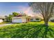 Charming single-story home with a well-manicured lawn and mature landscaping creating curb appeal at 1525 Fleetwood Dr, Sarasota, FL 34232
