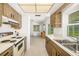 Functional kitchen featuring classic cabinets, tile flooring, and a view of the living area at 1525 Fleetwood Dr, Sarasota, FL 34232