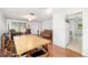 Open-concept living area with a dining table, laminate flooring, and abundant natural light at 1525 Fleetwood Dr, Sarasota, FL 34232
