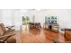 Spacious living room featuring laminate floors and sliding glass doors to backyard area with pool at 1525 Fleetwood Dr, Sarasota, FL 34232