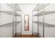 Walk-in closet with wire shelves and a full-length mirror at the end at 1525 Fleetwood Dr, Sarasota, FL 34232