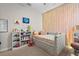 This bedroom includes lights on the wall and a window providing natural light at 15508 Leven Links Pl, Lakewood Ranch, FL 34202