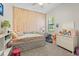 This bedroom includes lights on the wall and a window providing natural light at 15508 Leven Links Pl, Lakewood Ranch, FL 34202