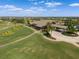 Exterior aerial view of a golf clubhouse, featuring well-manicured lawns, lush landscaping and serene golf course at 15508 Leven Links Pl, Lakewood Ranch, FL 34202