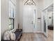 Bright foyer with light wood floors, bench seating, and a view into other rooms at 15508 Leven Links Pl, Lakewood Ranch, FL 34202