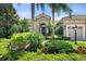 Beautiful home with a lush front yard and decorative plants around the front entrance at 15508 Leven Links Pl, Lakewood Ranch, FL 34202