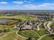 Aerial view showcases lush fairways, a picturesque clubhouse, and a sprawling golf course in a beautiful community at 15508 Leven Links Pl, Lakewood Ranch, FL 34202
