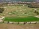 Aerial view of a verdant golf course with sand traps in a residential community with manicured greens and lush landscaping at 15508 Leven Links Pl, Lakewood Ranch, FL 34202