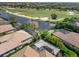 Scenic aerial view of homes overlooking a golf course with a serene pond and lush green fairways at 15508 Leven Links Pl, Lakewood Ranch, FL 34202