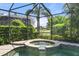 Relaxing screened-in hot tub overlooking the landscaped yard and pond at 15508 Leven Links Pl, Lakewood Ranch, FL 34202