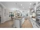 Contemporary kitchen with island, stainless steel appliances, and an open layout to living area at 15508 Leven Links Pl, Lakewood Ranch, FL 34202