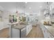 Modern kitchen with island, stainless steel appliances, and an open layout to living area at 15508 Leven Links Pl, Lakewood Ranch, FL 34202