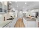 Modern kitchen with stainless appliances, gas cooktop, white cabinets and under cabinet lighting at 15508 Leven Links Pl, Lakewood Ranch, FL 34202